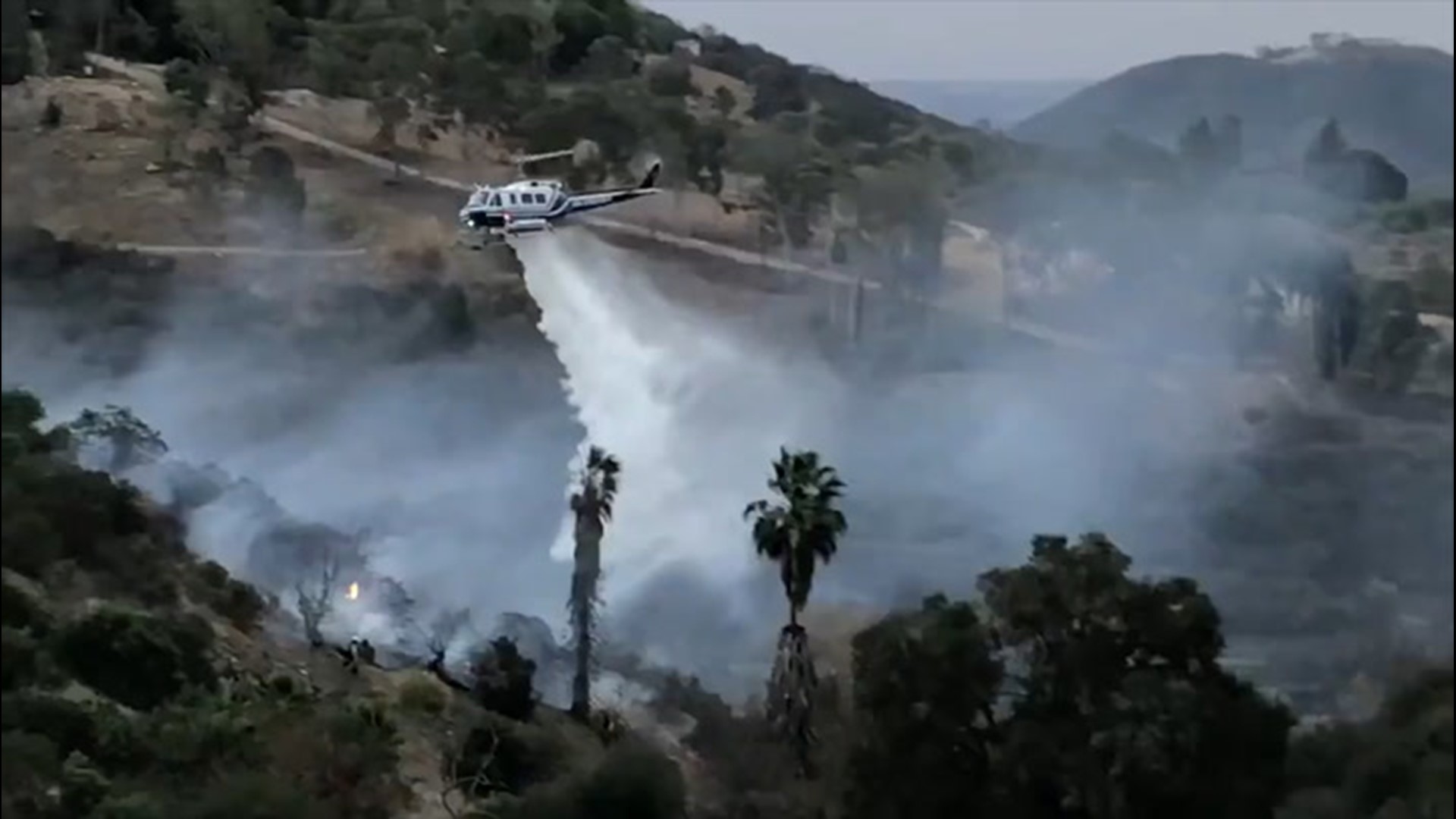 As multiple wildfires popped up across California on Jan. 19 with Santa Ana winds in the south and strong winds in the north, helicopter crews helped stopped the spread of the Ledge Fire.