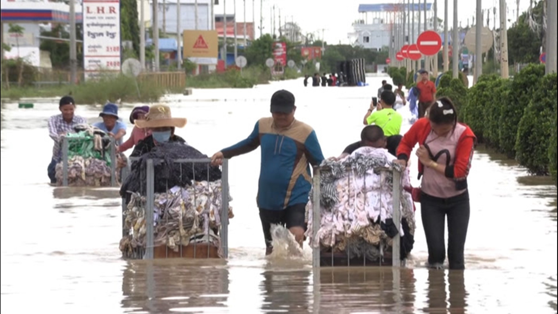 Residents of Phnom Penh, Cambodia, waded through floodwaters as they evacuated from their homes on Oct. 18. The heavy flooding caused at least 20 fatalities.