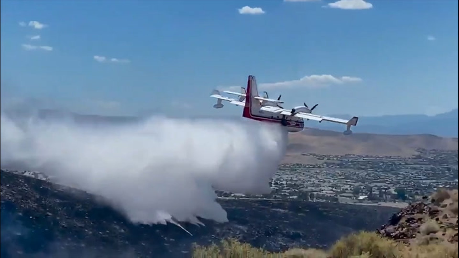 A water bomber dropped water on the Cielo Fire burning near Reno, Nevada, on July 2, as the fire forced some residents to evacuate.