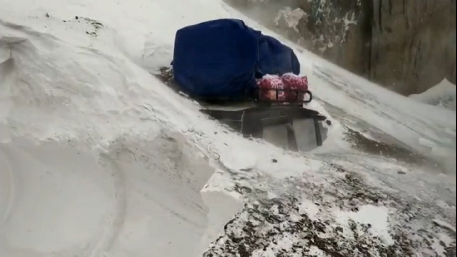 Police in Kashmir raced to save five people trapped in a vehicle after an avalanche swept downhill and onto a mountain pass, burying the vehicle on Nov. 29.