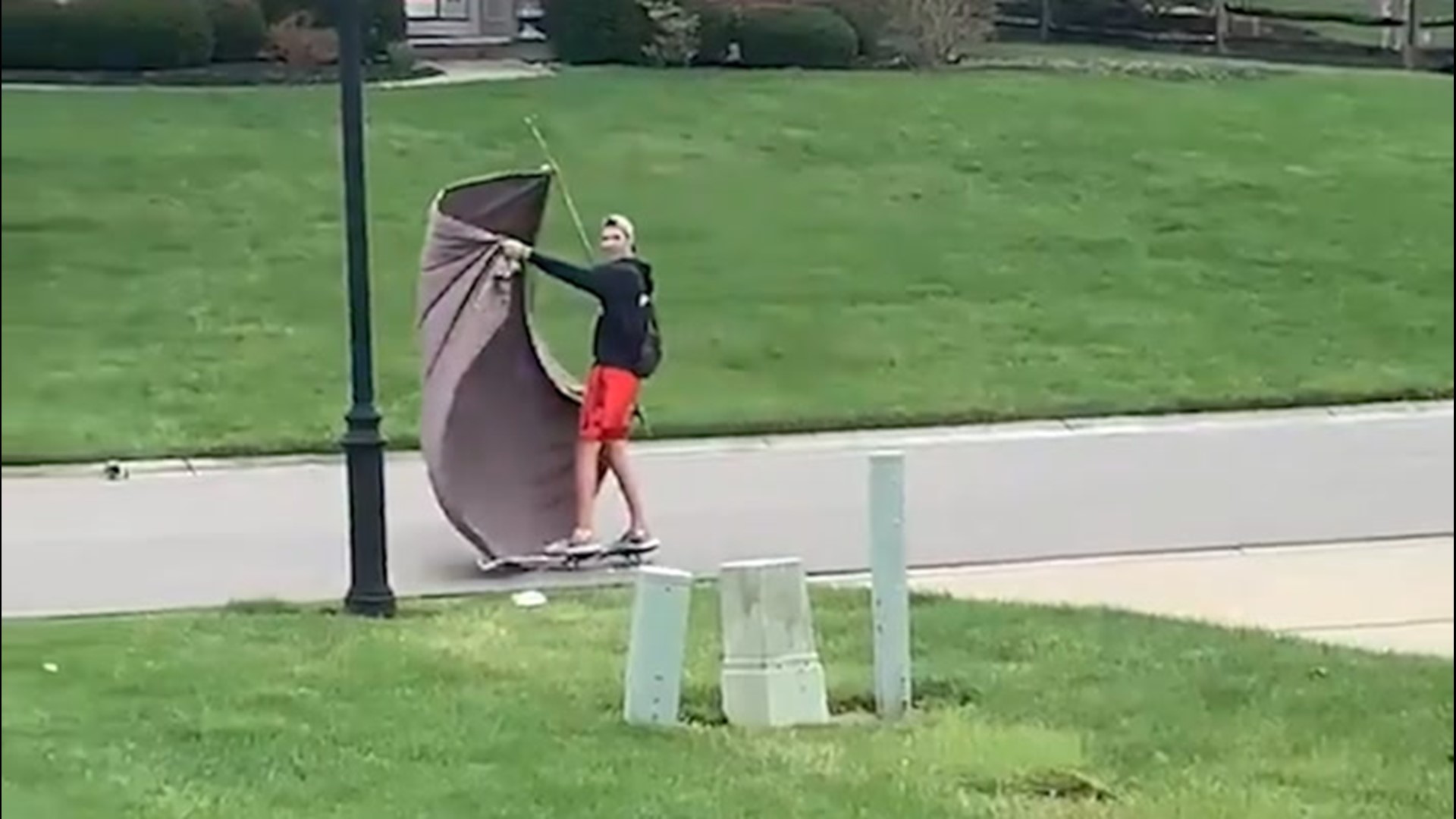 As winds picked up in Ohio on Sunday, March 28, one teen combined a skateboard with a stick and a large piece of cloth to 'sail' down his neighborhood street.