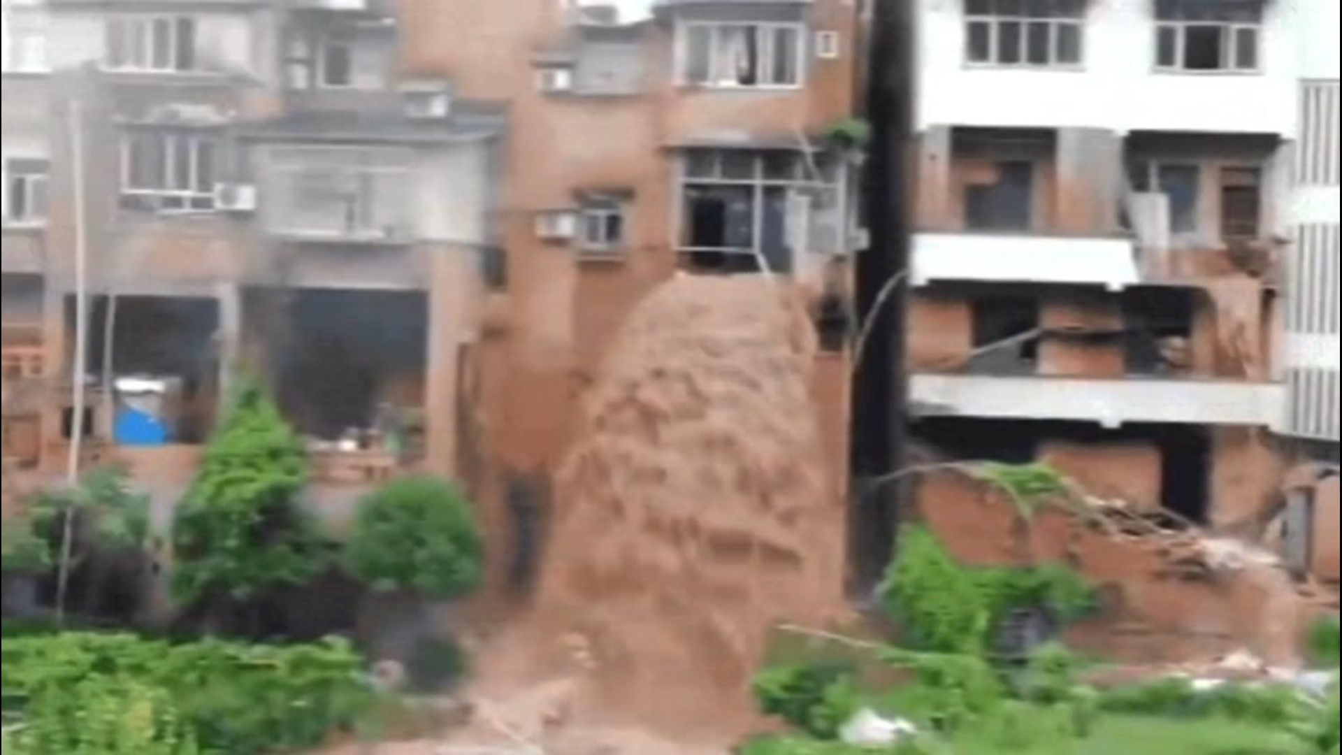 A rainstorm inundated the city of Chongqing, China, on July 1, with severe flooding. Floodwaters poured out of this building like a waterfall.