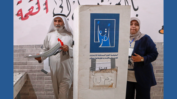 Iraqis vote in a parliamentary election marked by tight security and a major political boycott