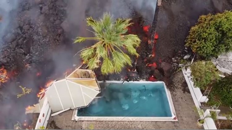 Drone video shows lava from Spain volcano destroy homes, swimming pool