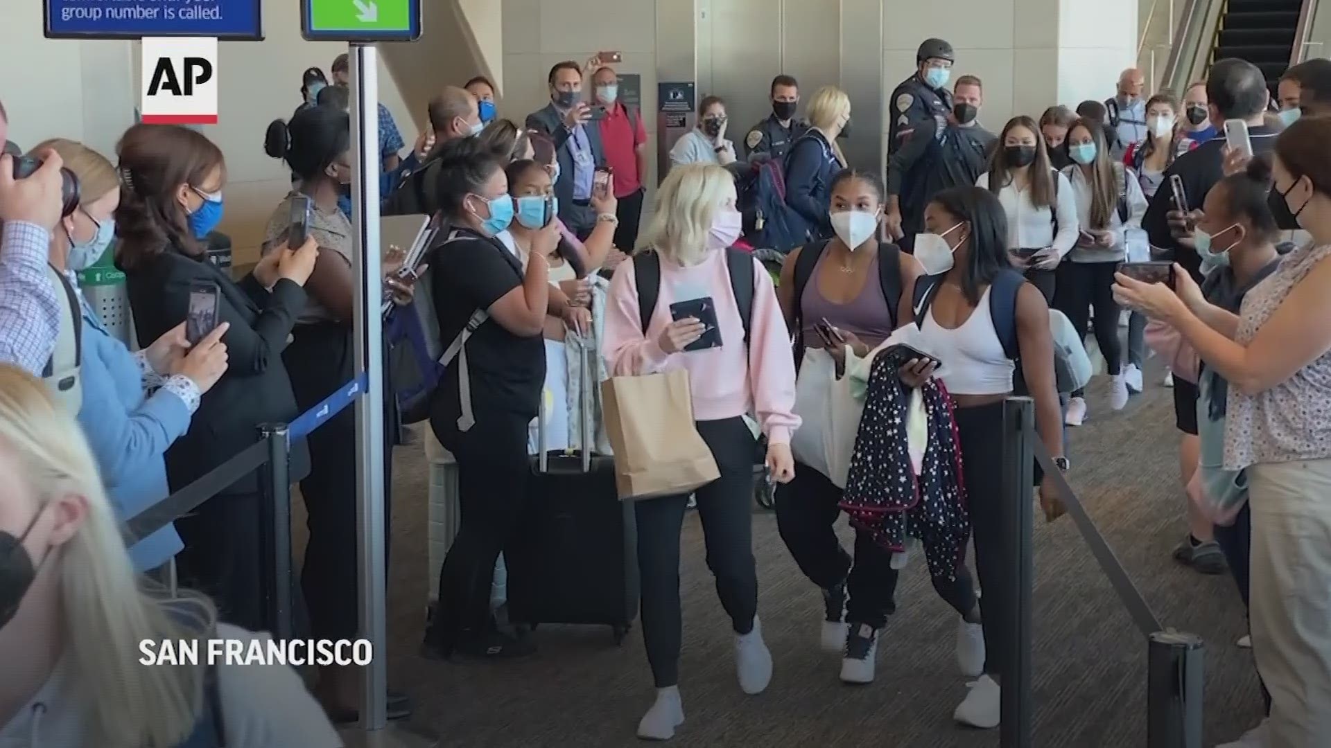 U.S. gymnastics star Simone Biles and her teammates boarded a flight Wednesday to Tokyo from San Francisco International Airport for the Olympic Games.