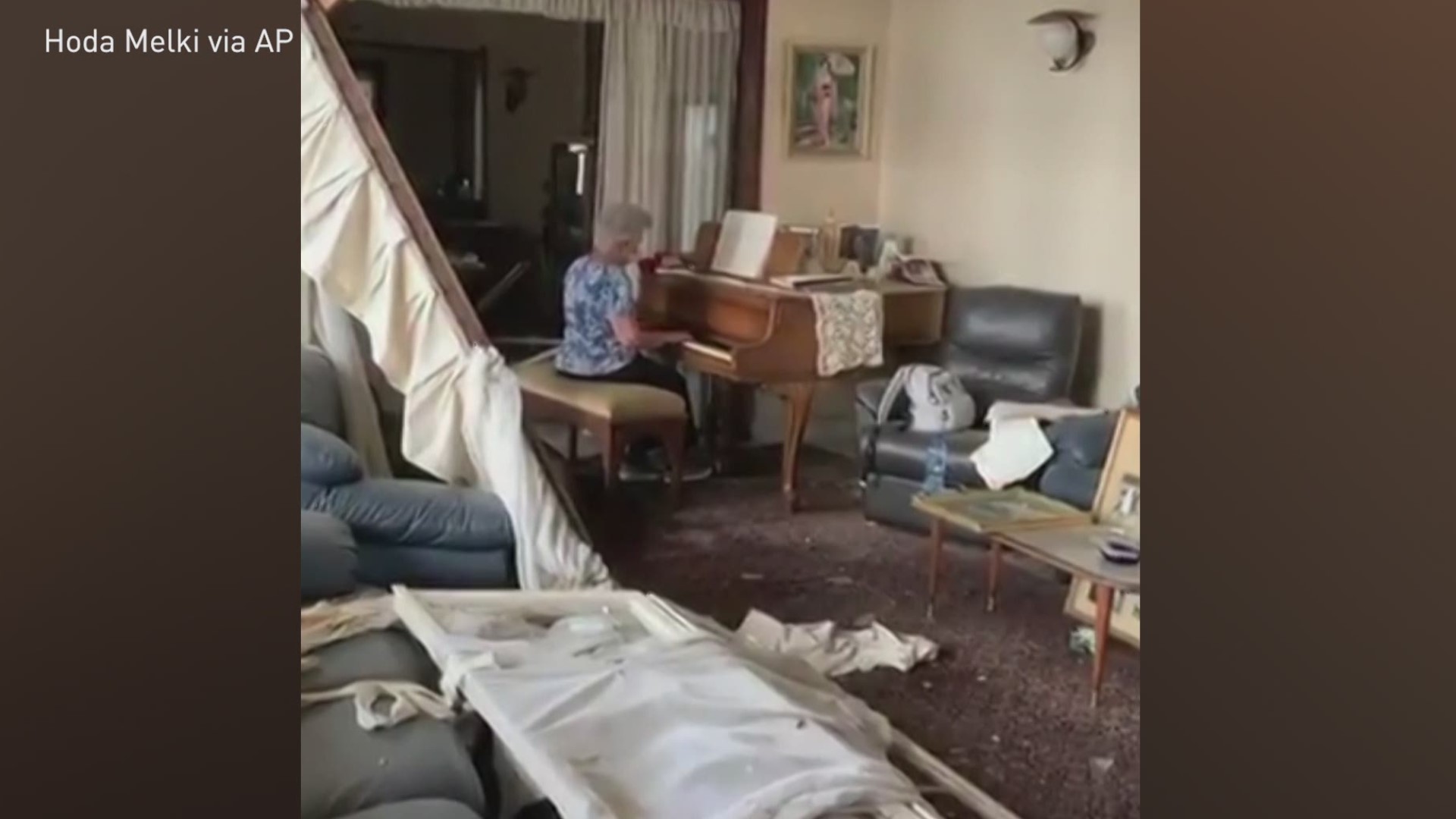 Beirut resident Hoda Melki recorded a video of her mother playing 'Auld Lang Syne' on a piano amid debris in her home the day after it was damaged by an explosion.