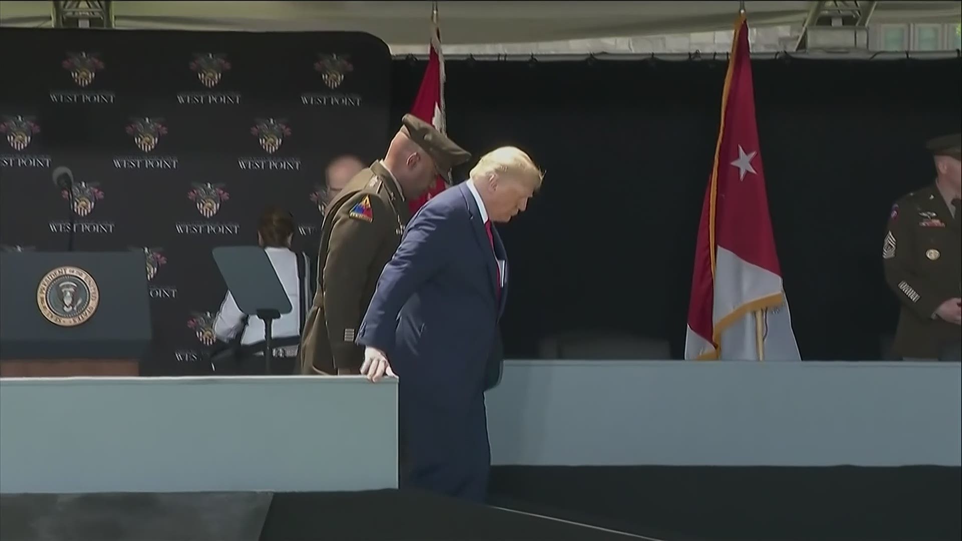 President Trump descends a ramp after giving the commencement address at West Point.