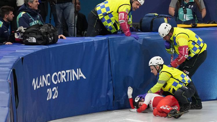 Kamila Sellier of Poland is helped after a fall during the women's 1,500 meters short track speed skating quarterfinal at the 2026 Winter Olympics.