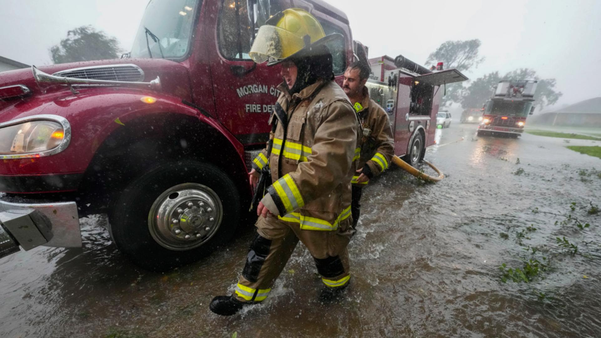 Heavy rain has submerged cars in New Orleans with wind downing trees and powerlines in several nearby parishes.