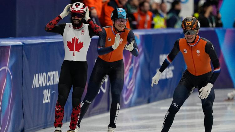Steven Dubois of Canada, and Melle van 't Wout, left, and Jens van 't Wout of the Netherlands in the short track men's 500m. (AP Photo/Ashley Landis)