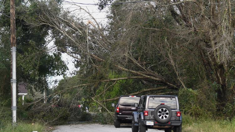 Isaias weakens but flooding threats persist as hundreds of thousands grapple with power outages