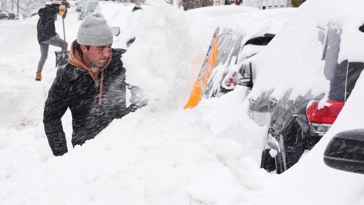 Residents dig out their cars in the South Boston neighborhood following a winter storm across the region, Jan. 26, 2026.