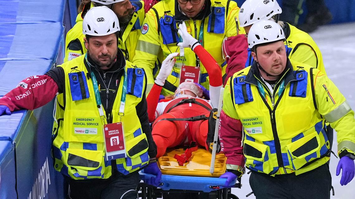 Kamila Sellier of Poland is helped after falling during a short track speed skating women's 1500 meters quarterfinal at the 2026 Winter Olympics.