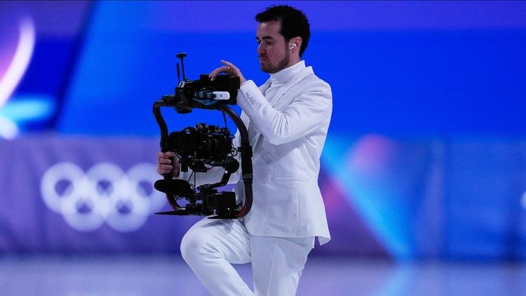 Jordan Cowan operates the steadicam before the pairs figure skating short program at the 2026 Winter Olympics, in Milan, Italy, Feb. 15, 2026.
