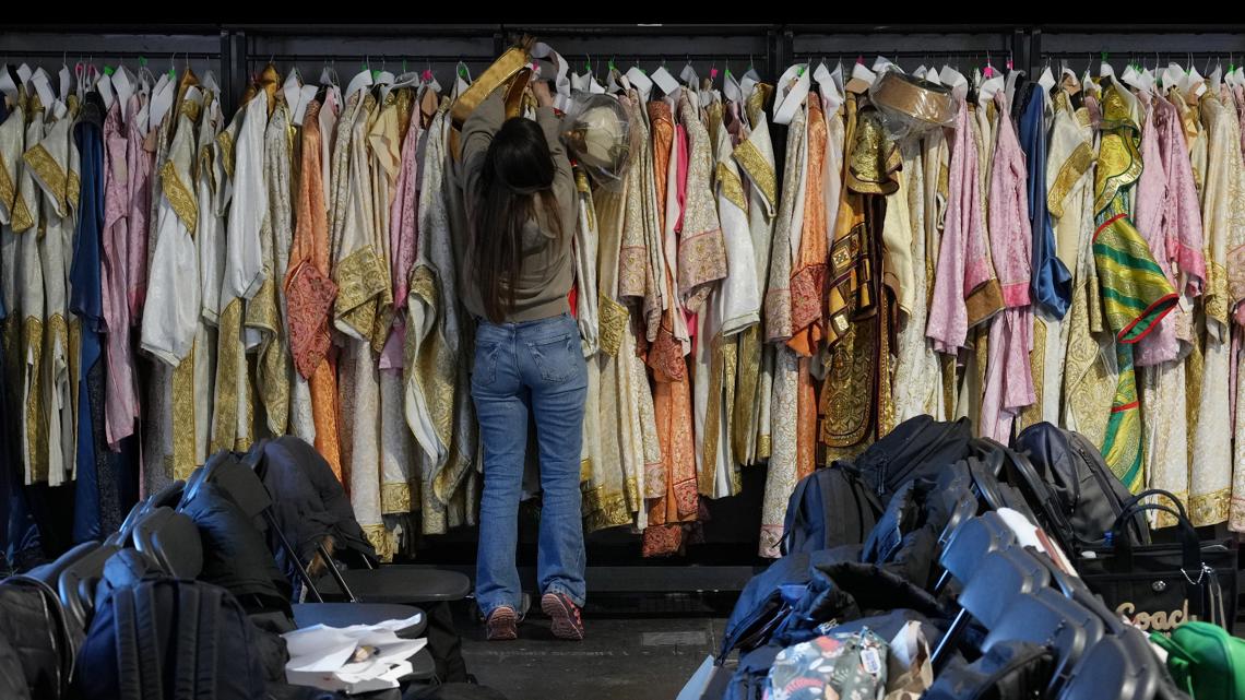 Dressmaker Luciana Donadio works in a dressing room outside the Arena ahead of the closing ceremony at the 2026 Winter Olympics, in Verona, Italy.