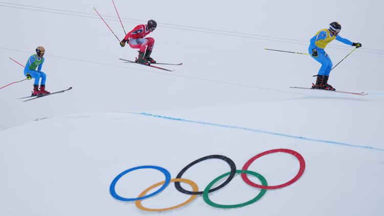 From left, Italy's Dominik Zuech, Canada's Reece Howden and Italy's Federico Tomasoni in the men's ski cross final in Livigno, Italy, Feb. 21, 2026.