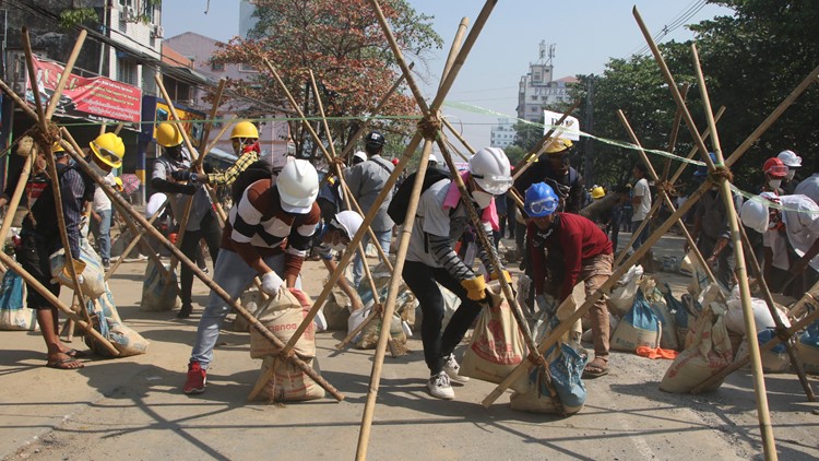 Myanmar crisis heightens with police raids and strike call