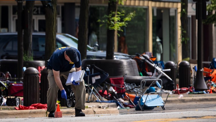 Parents of boy, 2, found alone at parade shooting among dead