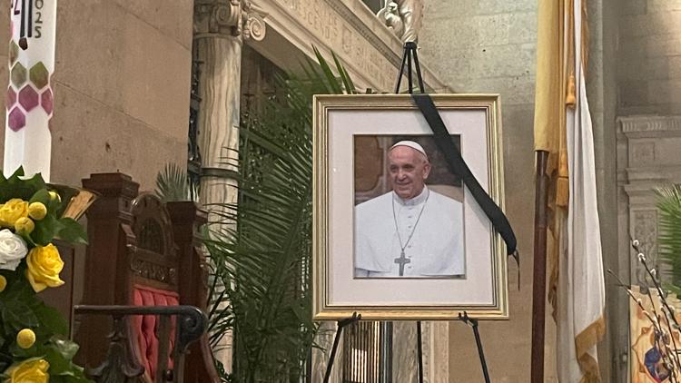 Flags fly at half staff, black drapes line the basilica after Pope Francis' passing