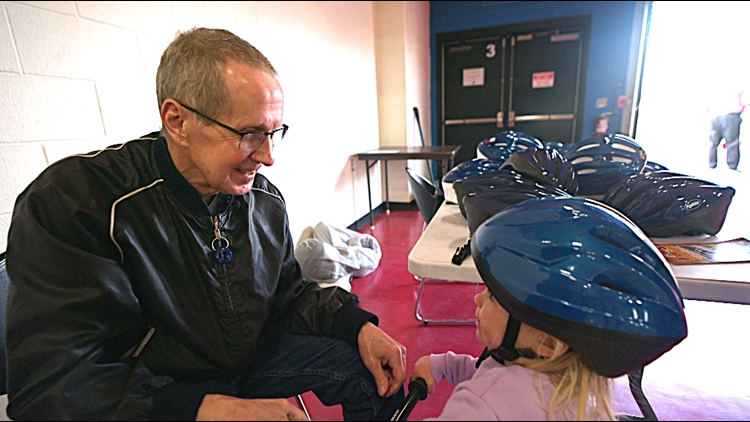Brain injury survivor on mission, gives 22,000 bike helmets to kids