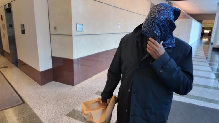 Medicaid fraud suspect hides face outside court as federal charges echo KARE 11 investigation