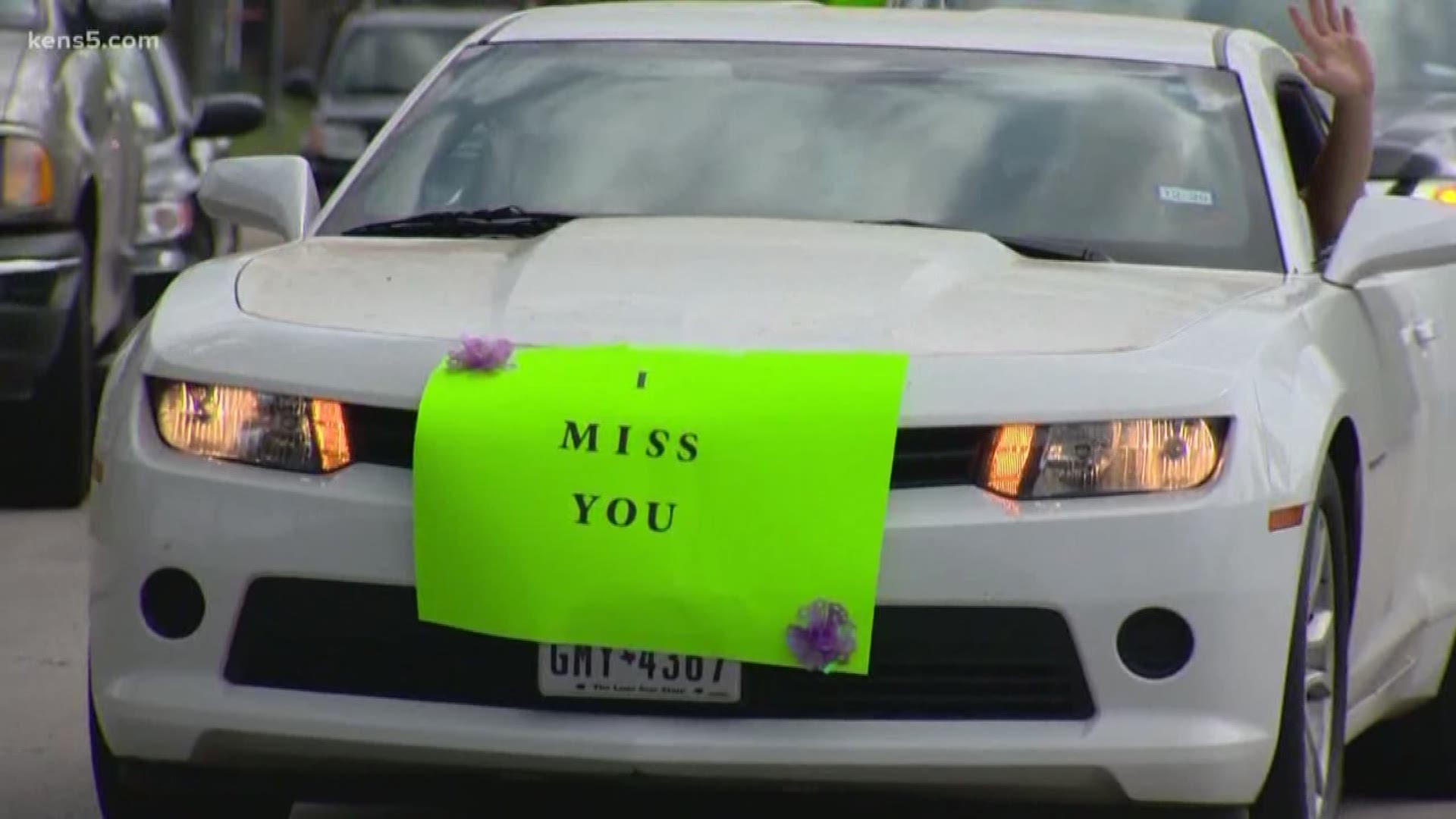 Teachers taped handmade signs to their cars that read "We Miss You" and "Wash Your Hands."