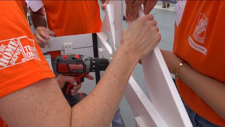 Hundreds of volunteers transform USS Midway into donation workshop for military families