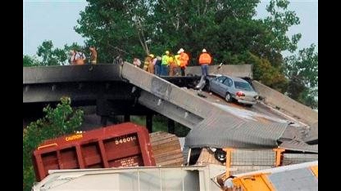 Freight Train Crash Causes Highway Overpass to Collapse