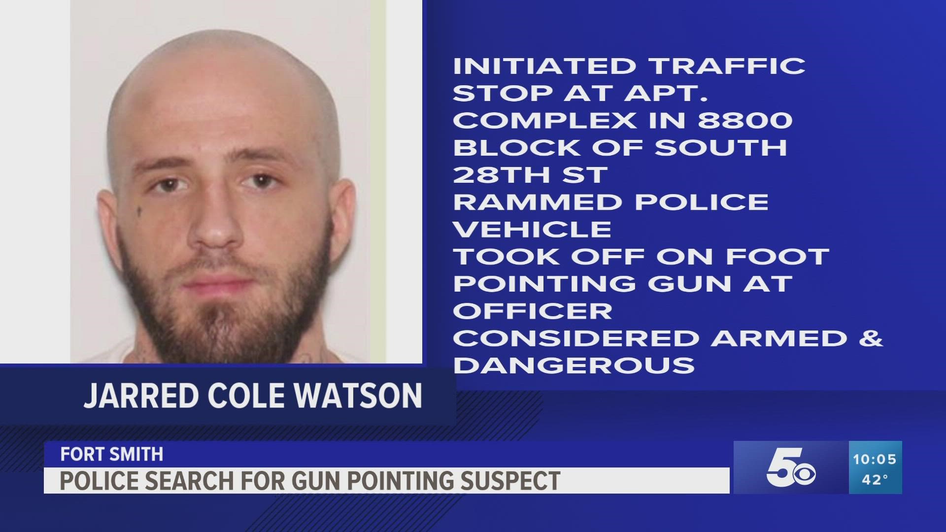 Watson revved his motorcycle engine and rammed the police vehicle, then took off running while pointing a firearm at an officer, according to police.