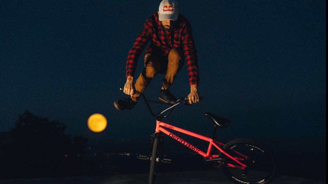 Professional BMX  flatland  rider rides under the Harvest 