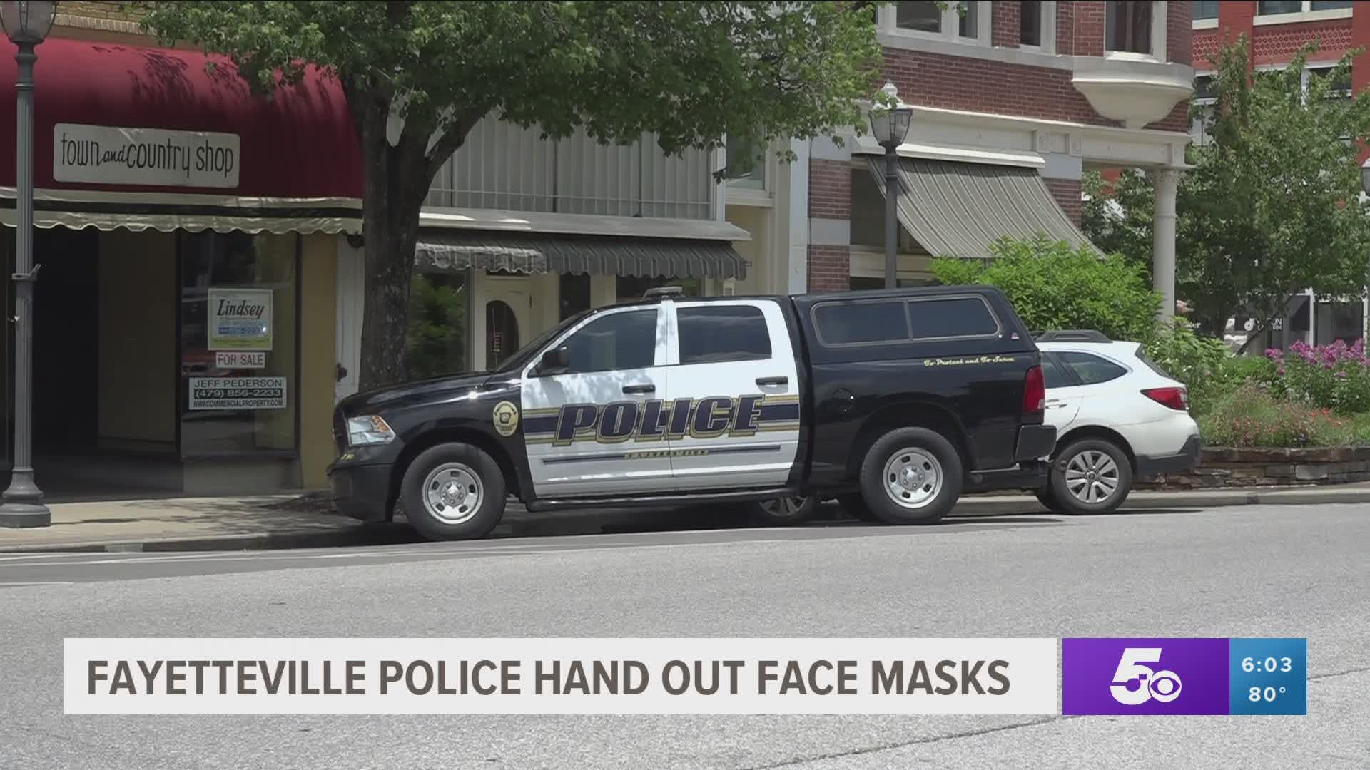 Fayetteville police hand out face masks.
