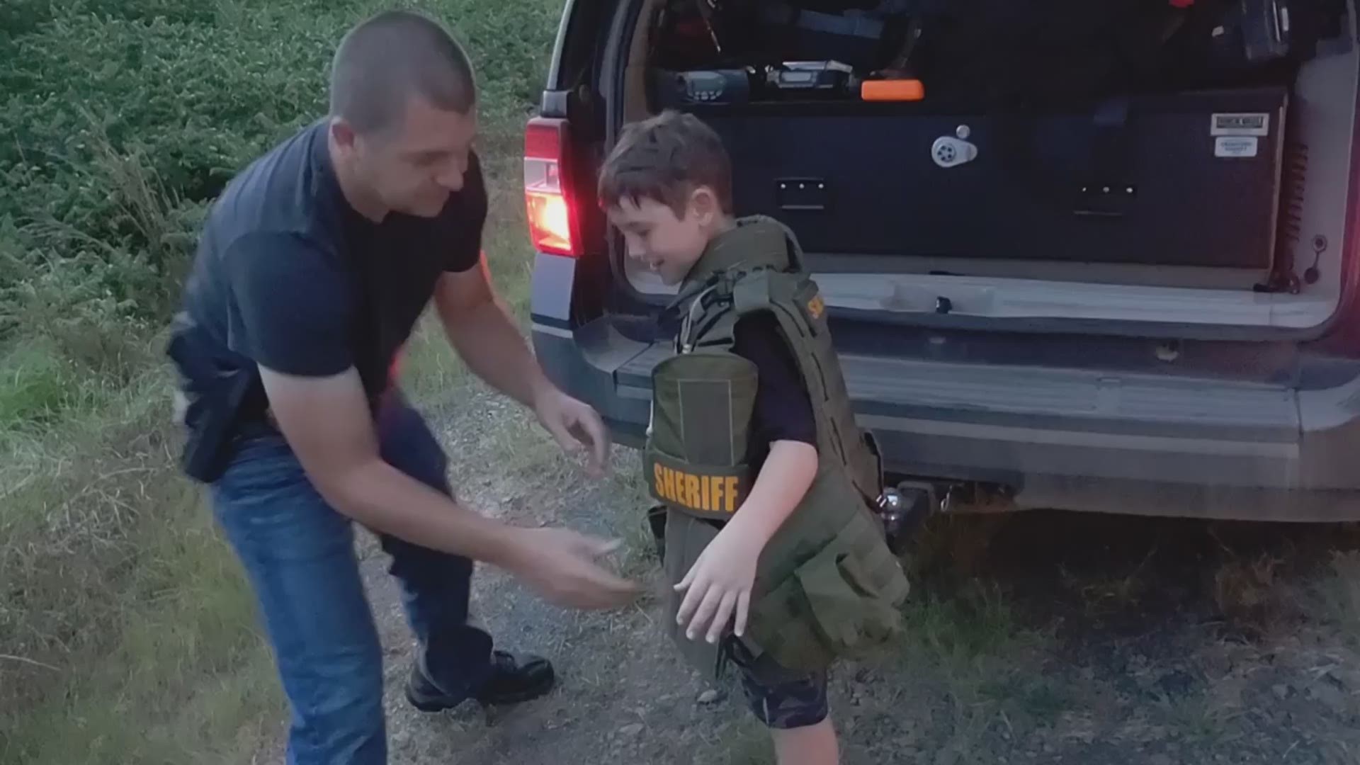 He gave two kids a treat when he let them try on his swat gear and told them what it was used for.