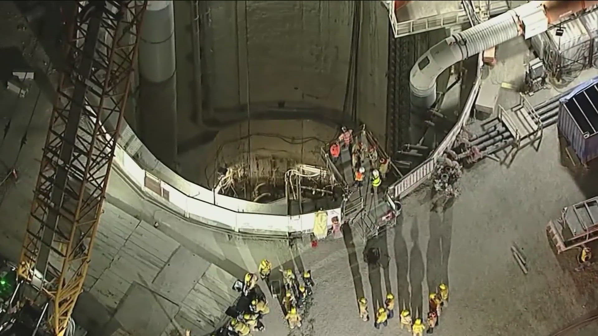 The L.A. Fire Department said the trapped workers were able to climb over a 12- to 15-foot-high pile of loose soil to reach the other side.