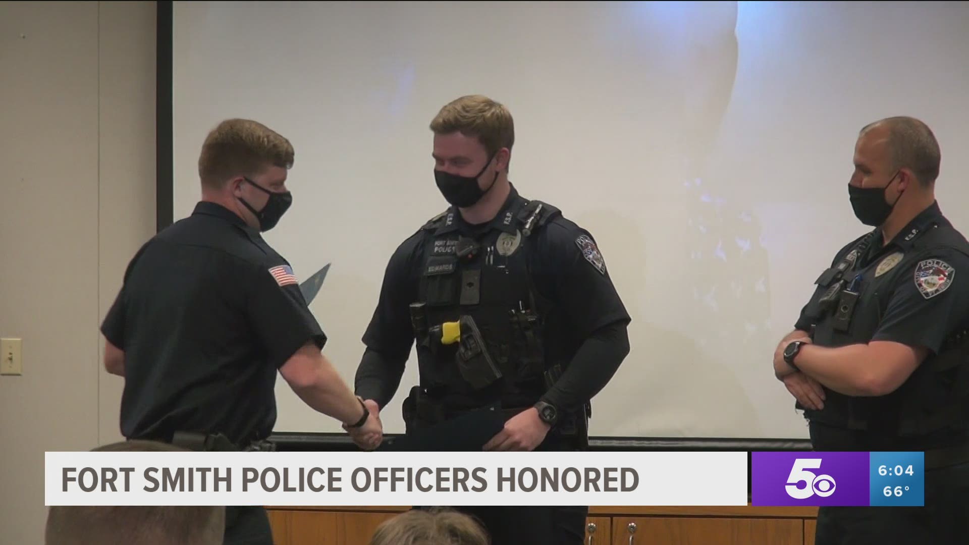 Two Fort Smith officers were given praise and awards Friday for de-escalating a situation where a man was threatening to kill himself and a toddler with a knife.