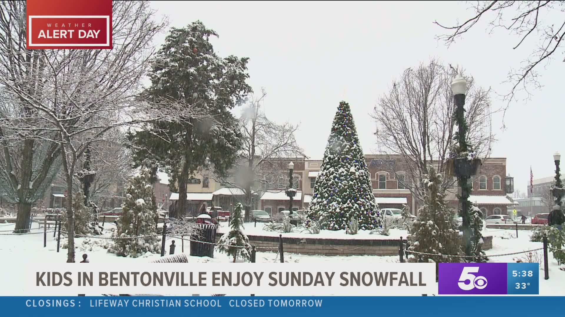 Kids in Bentonville enjoy Sunday snowfall at Bell Park.