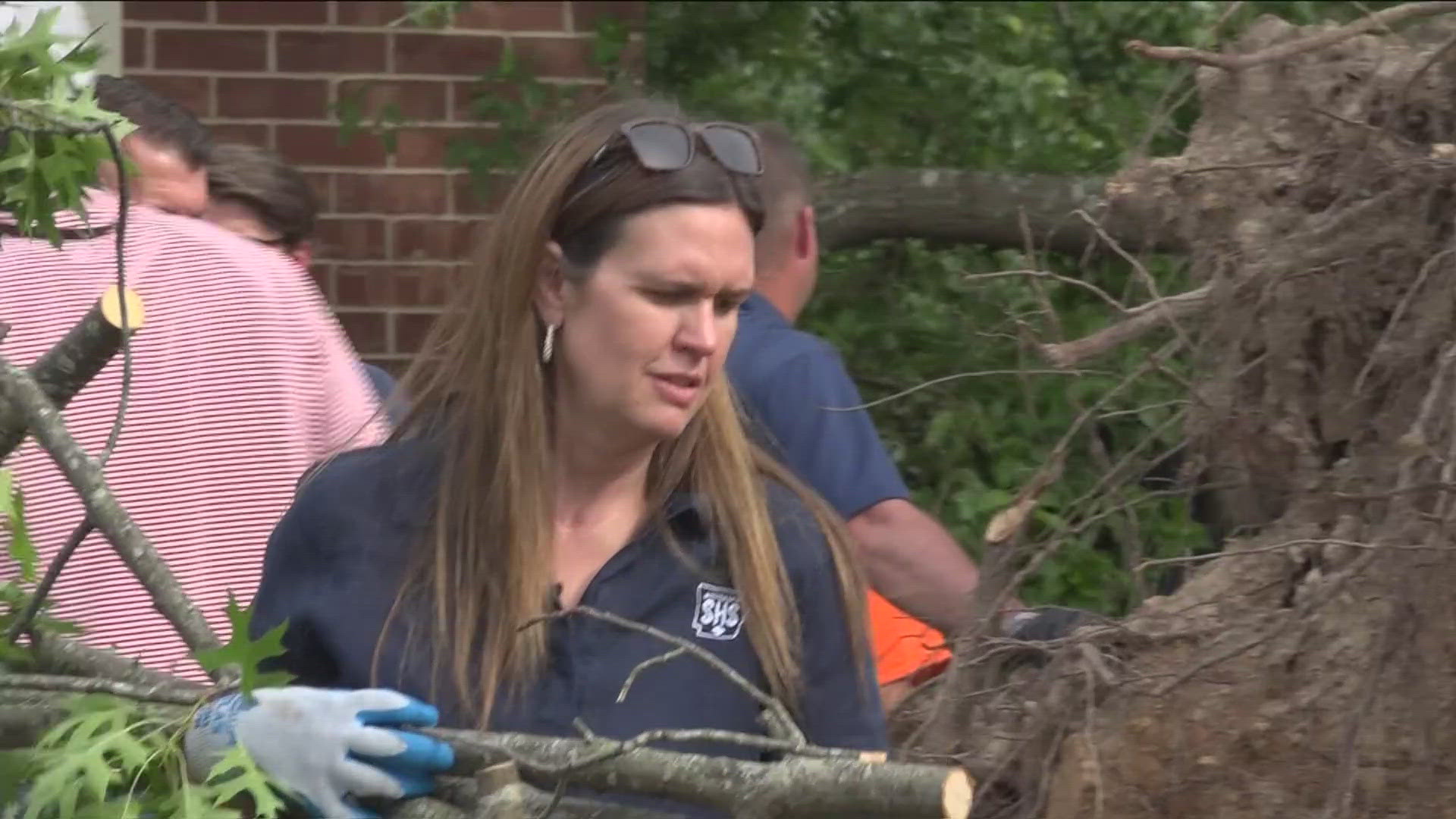 Volunteers, including people like Razorback Coach John Calipari, spent the evening cleaning debris from homes affected by the storms.