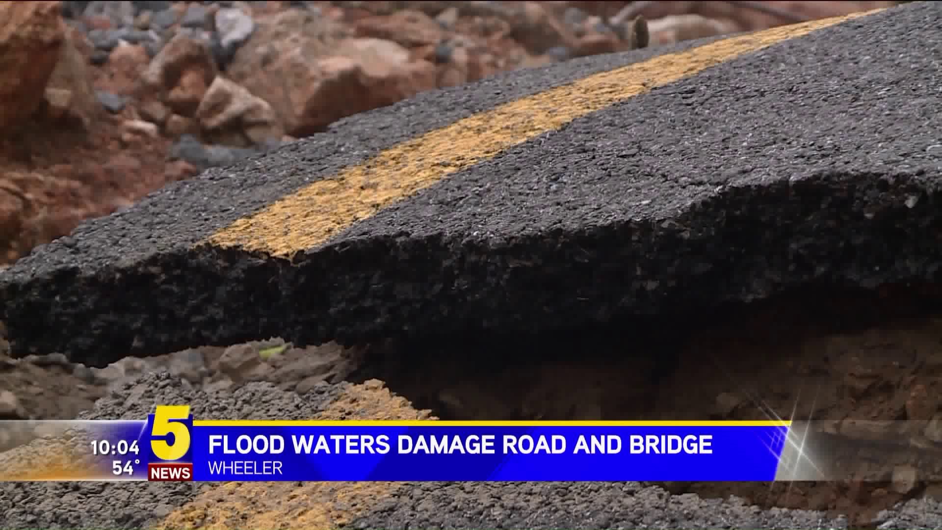 Flood Waters Damage Road and Bridge