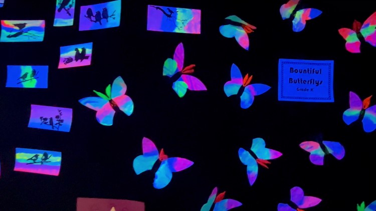 Students at First Lutheran School in Fort Smith show off their creativity with black light art