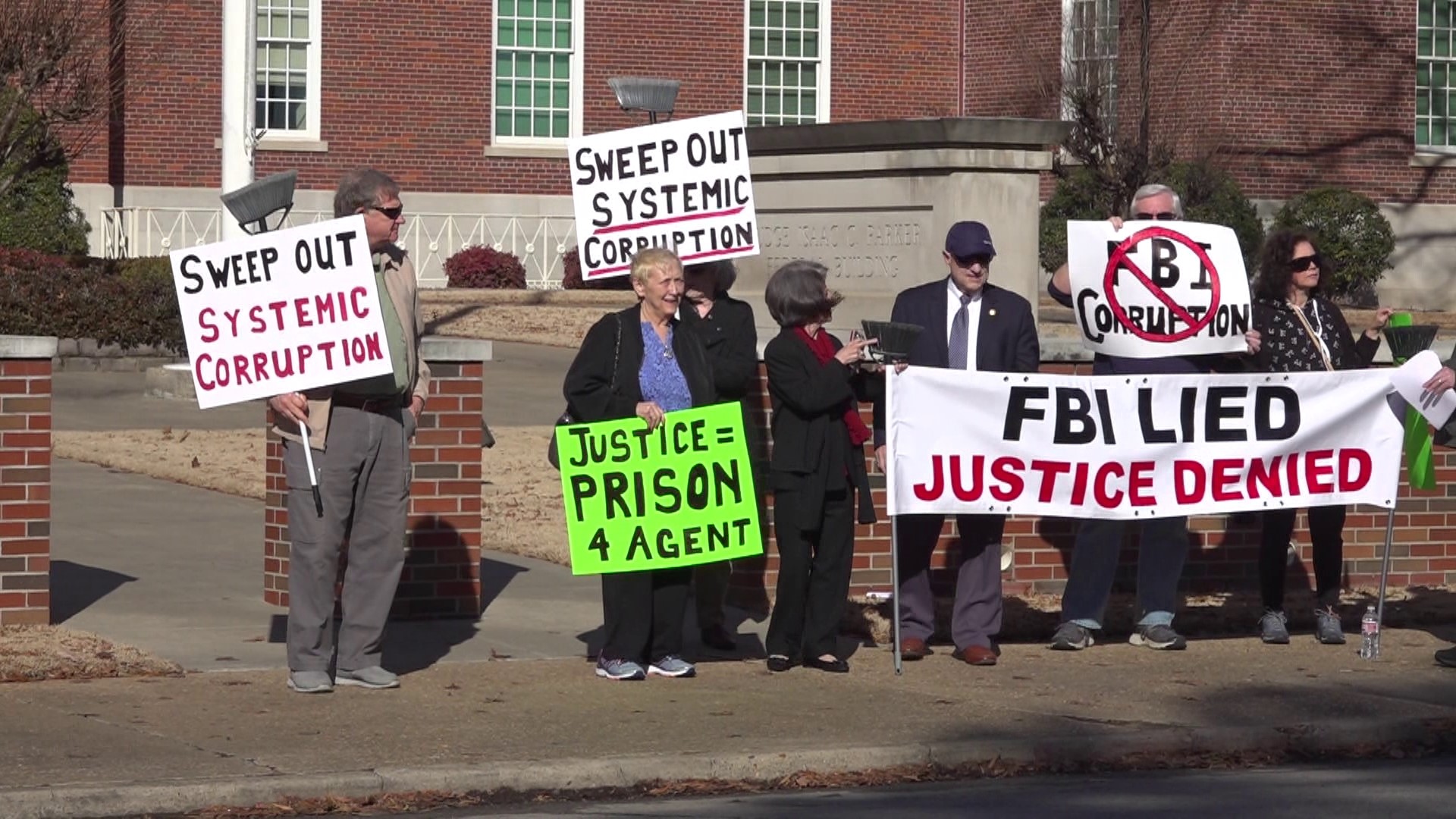 Fort Smith citizens protest outside the courthouse where a former FBI Agent will be sentenced for evidence destruction in an Arkansas State Senator's corruption case