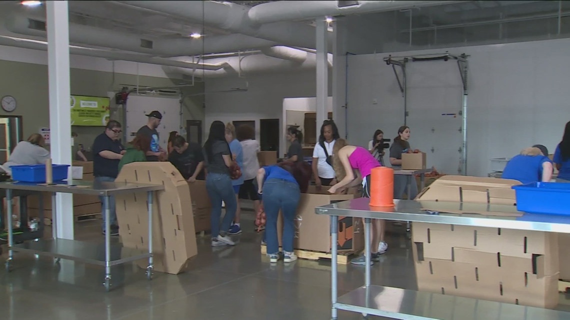 Walmart associates pack boxes at Northwest Arkansas Food Bank for ...
