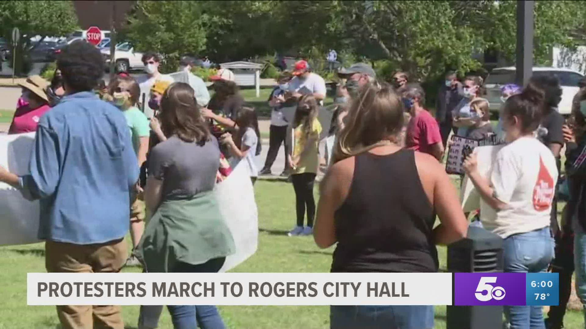 Protesters march to Rogers City Hall