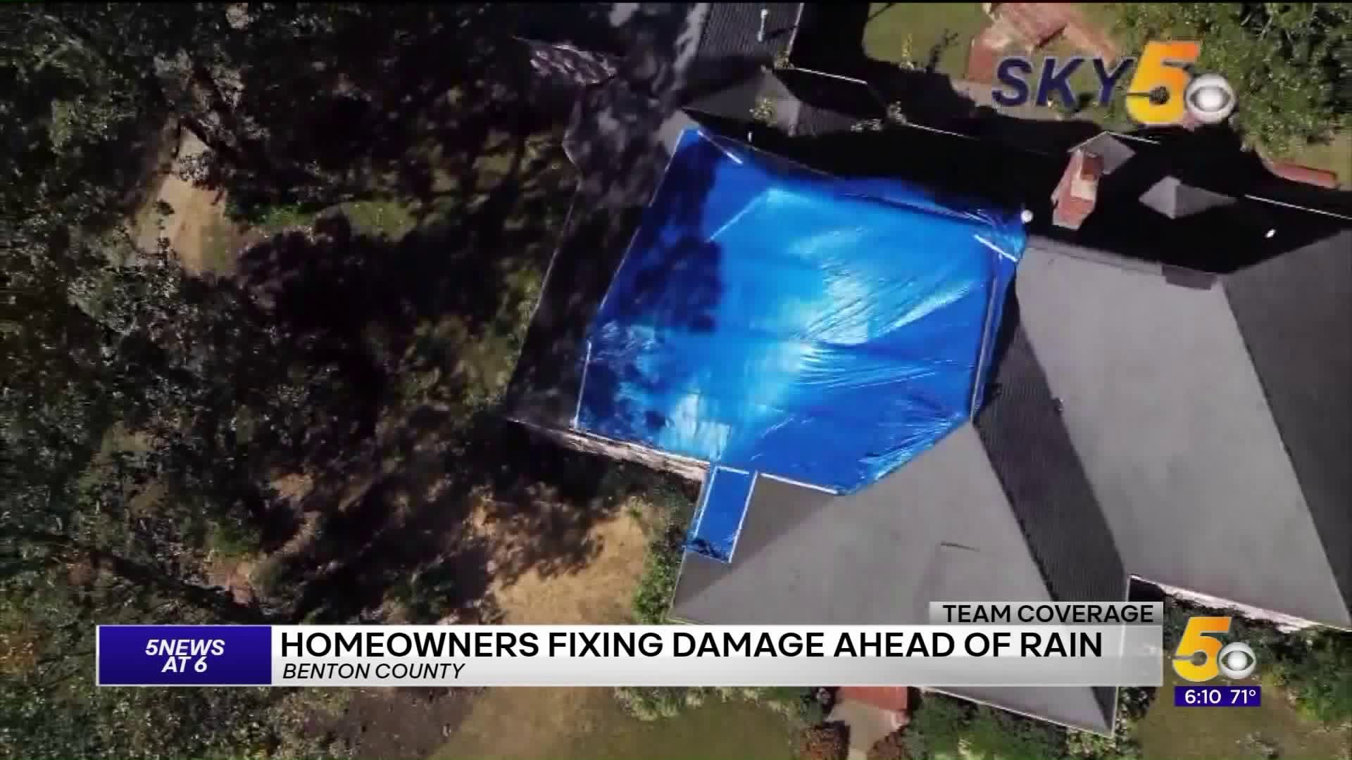 Homeowners Repairing Damage Ahead of Rain