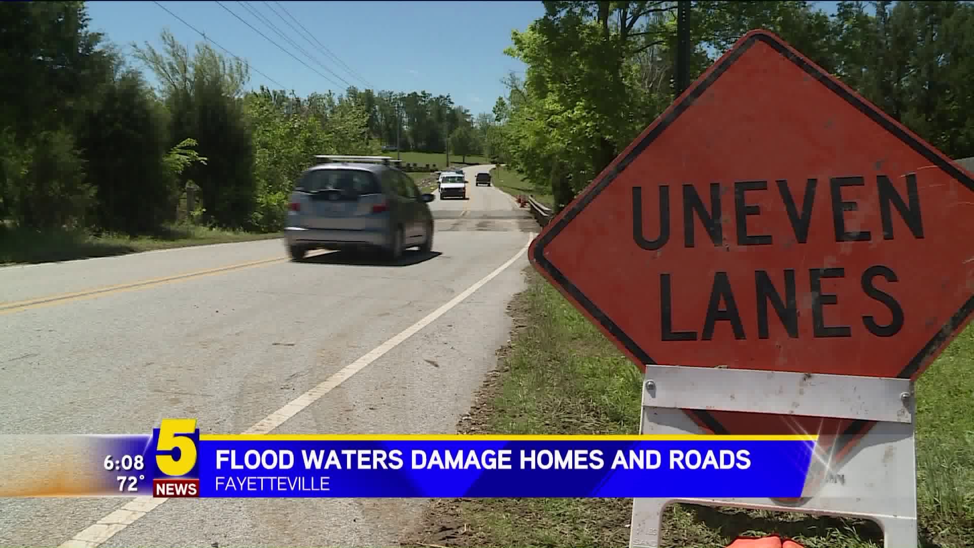 Flood Waters Damage Roads and Homes