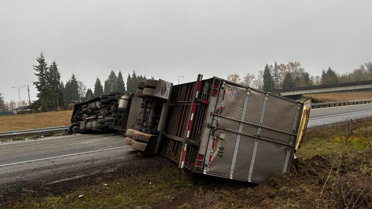 Semi-truck rollover blocks I-5 in Castle Rock; driver cited for negligent driving