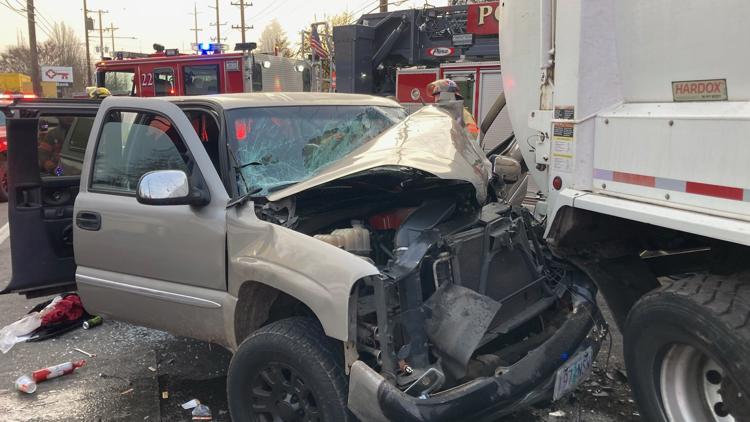 Driver pulled from vehicle after crash with garbage truck in Portland