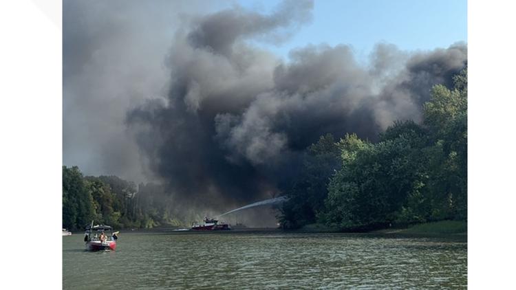 Old equipment and tractor tires on fire on Ross Island and Willamette River sends plume of smoke across metro area