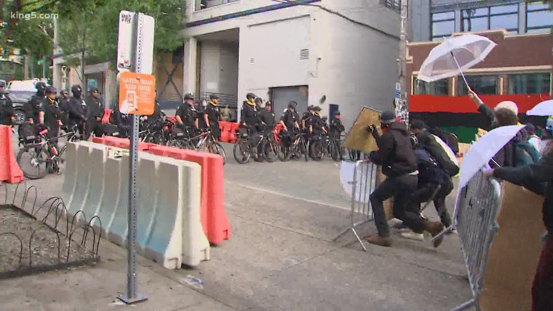 Protesters in Seattle's Capitol Hill neighborhood moved a barricade to get closer to Seattle police's East Precinct. SPD is decreasing presence at protests.