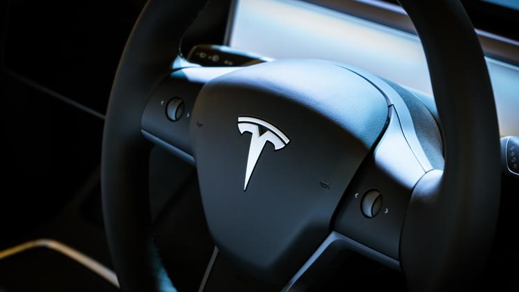 Driver arrested after backing into, pinning repo man with Tesla in Arlington
