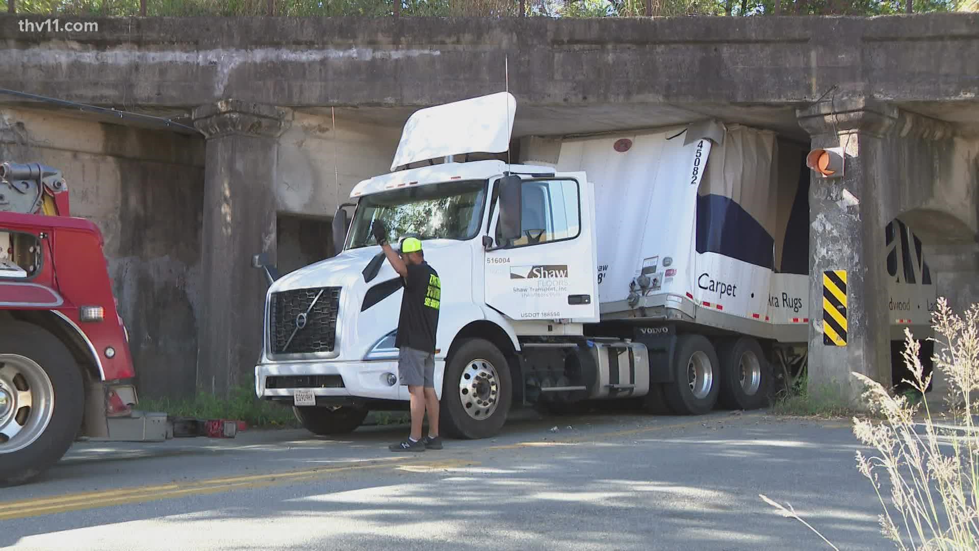 A semi-truck is causing traffic delays after it crashed under a railroad overpass on 6th Street in Little Rock.