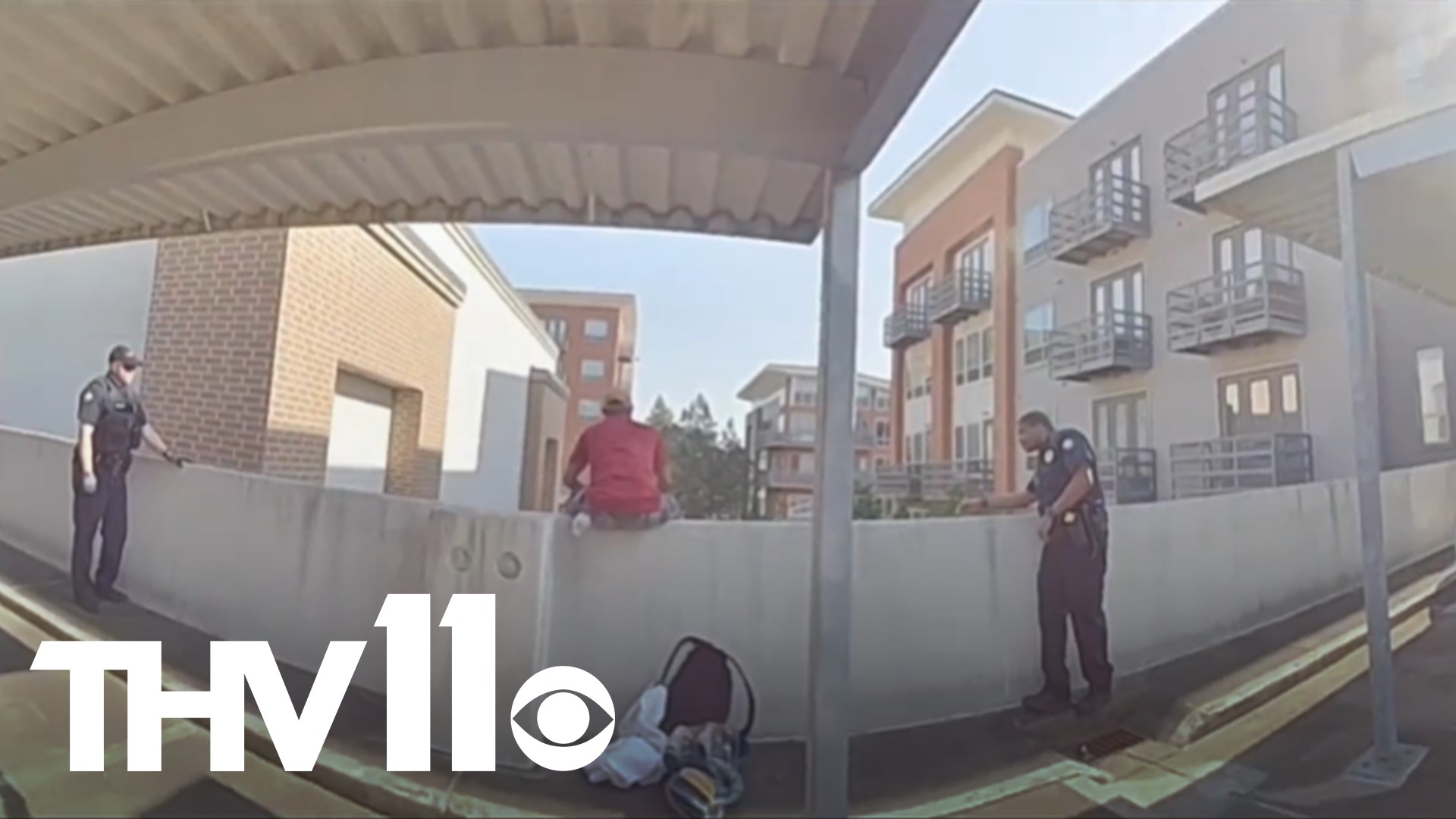 A video shows Little Rock police officers pulling a man from ledge of parking deck, likely saving his life.